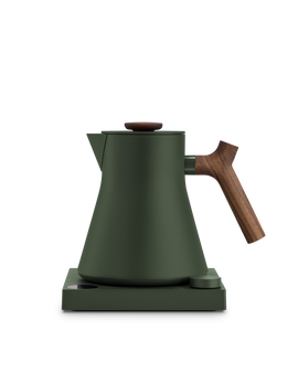 Fellow Corvo EKG Electric Kettle in matte green with wooden handle on a matching base.