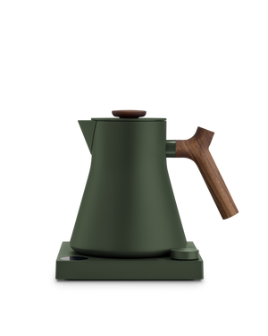 Fellow Corvo EKG Electric Kettle in matte green with wooden handle on a matching base.