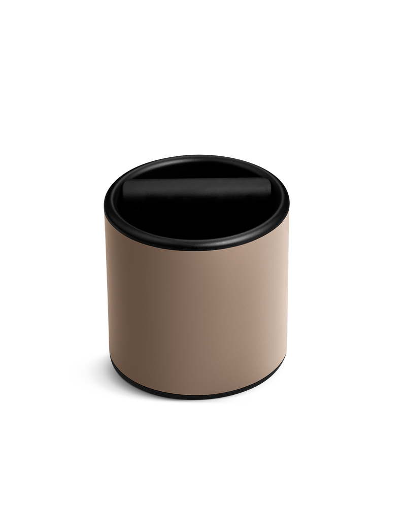 The Fellow Espresso Knock Box in Malted Chocolate has a swing lid and silicone-wrapped knock bar.