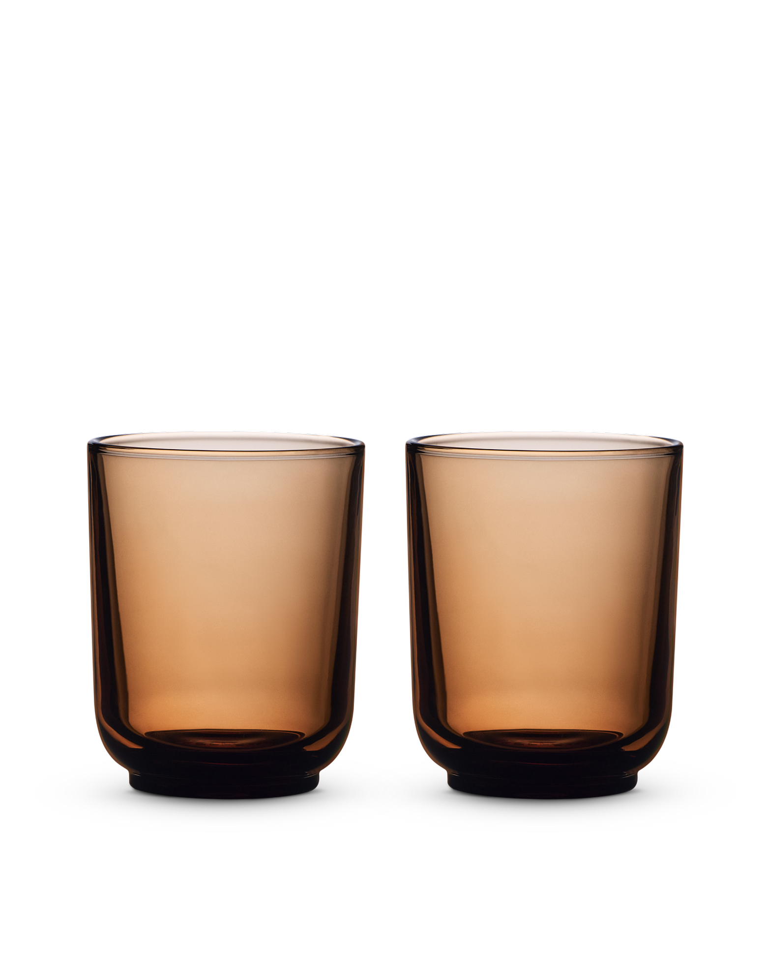 Two Fellow Pirch Espresso Glasses in amber sit on a white background.