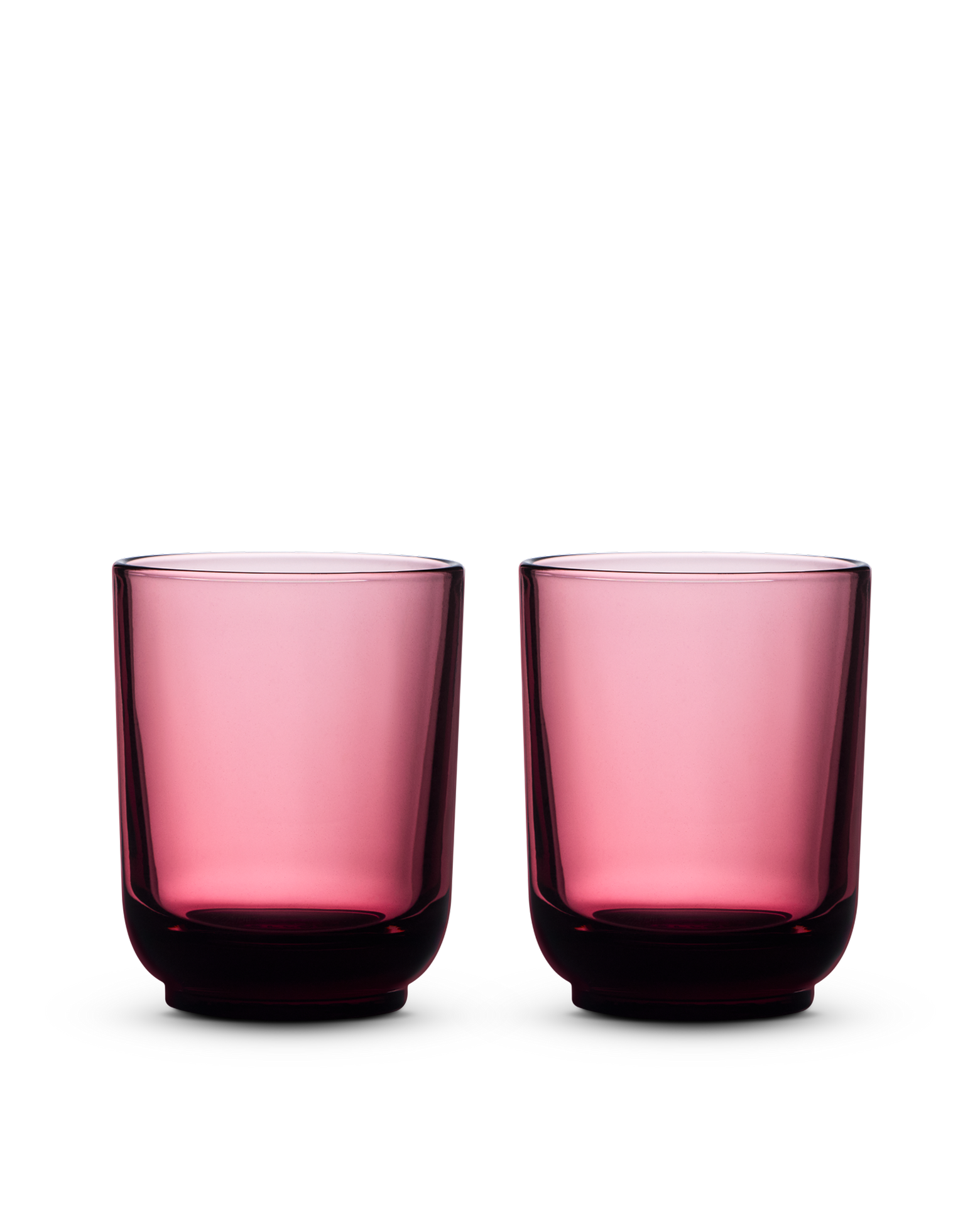 Two Fellow Pirch Espresso Glasses in pink displayed on a white background.