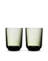 Two green Pirch Espresso Glasses by Fellow with rounded bases on a white background.