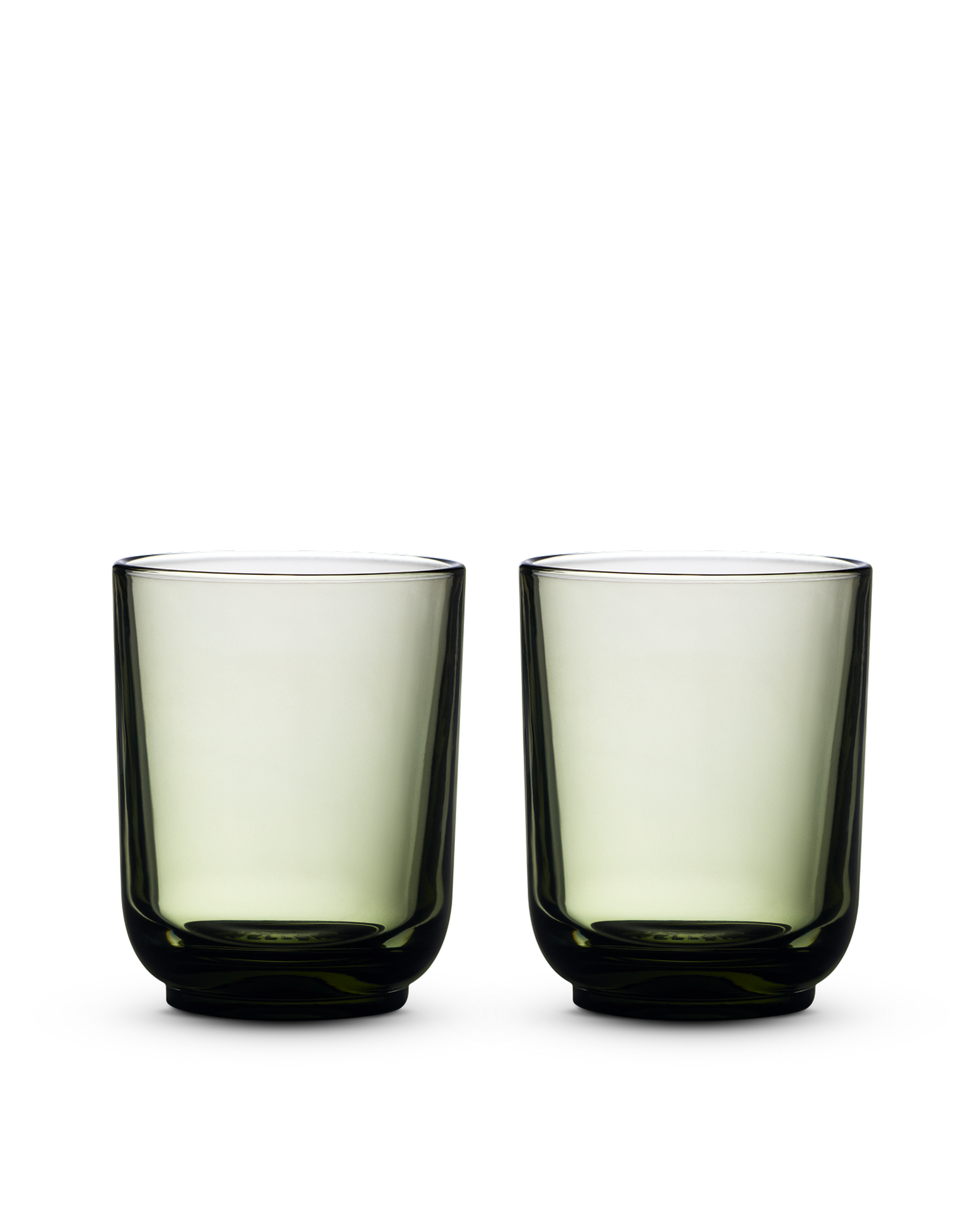 Two green Pirch Espresso Glasses by Fellow with rounded bases on a white background.