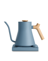 The Fellow Stagg EKG Electric Kettle: modern blue, wood handle, heats quickly, matching base.