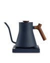 Fellow Stagg EKG electric kettle in matte navy with wooden handle, ideal for precise brewing.