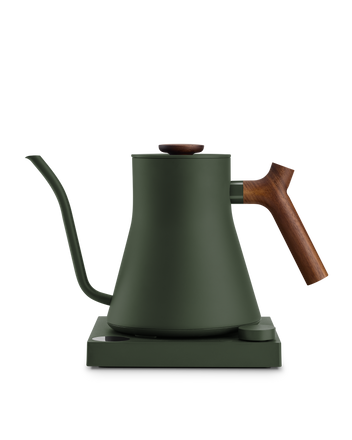 Fellow Stagg EKG matte green electric kettle with wood handle, gooseneck spout, and base.