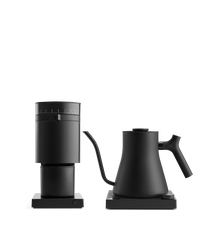 Fellow's The Electric Kit: sleek black grinder and kettle on square bases, white background.