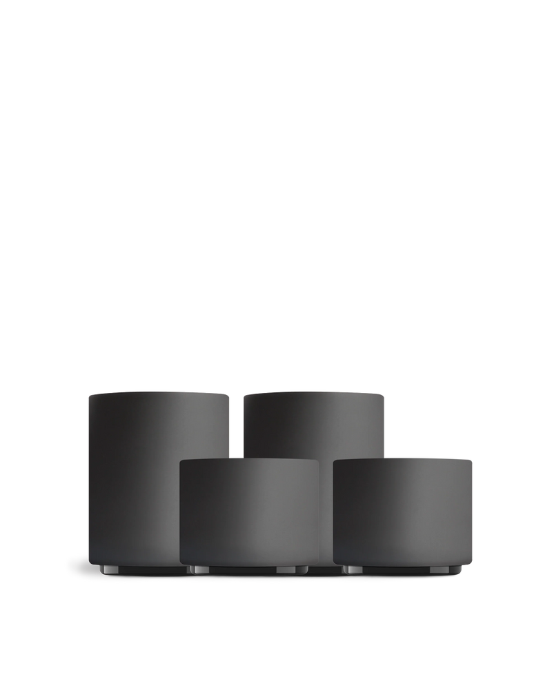 Four matte black Fellow Latte Art Set cups in different sizes on a white background.