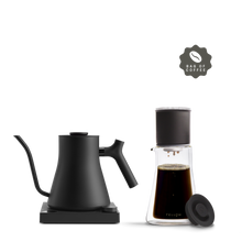 Fellow The Pour Over Kit: black electric kettle, glass brewer, and coffee bag icon on white.