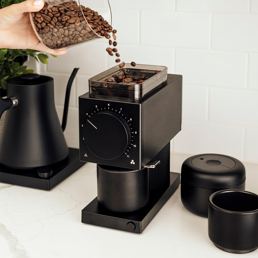 Coffee beans poured into ode brew grinder - media